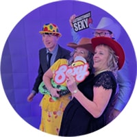 Wedding guests posing with prop signs in front of the Inflatable Photo Booth in Leicester